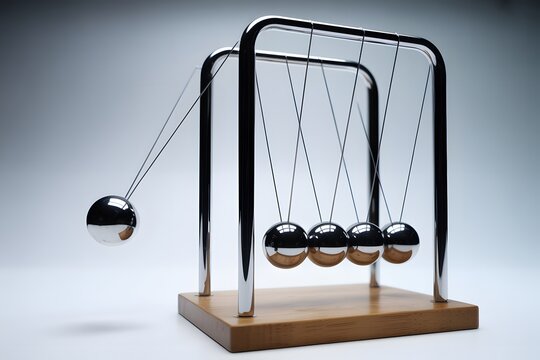 Newton's cradle with black metal spheres in motion