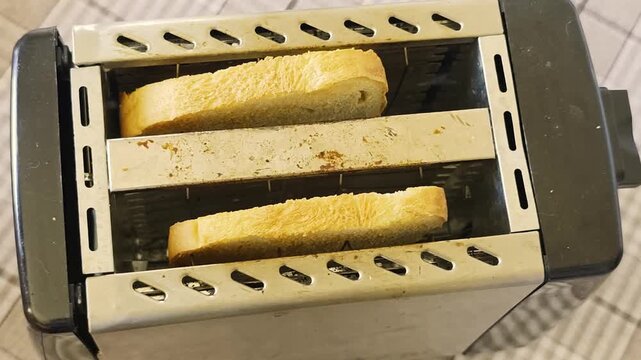 Toast is being made in a toaster with the bread changing color over time