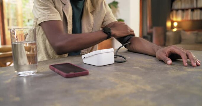 Man sitting at home starting blood pressure check, wrapping cuff, pressing monitor, copy space