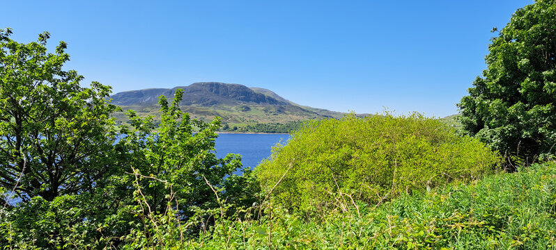 Llyn Celyn, Wales viewed from above on a sunny summers day as the photographer travels by road around the lake, annoying the wonderful scenery and vibrant colours.