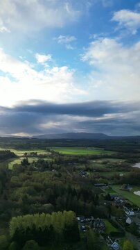 Aerial View of Balmaha Valley Glasgow Landscape over Mountains of UK During Sunset Time. The village is a popular tourist destination for picnickers and day trippers from Glasgow Scotland, UK