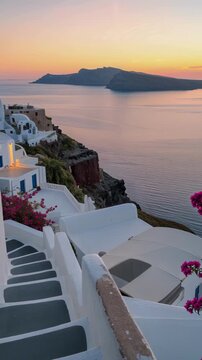 Magical Sunset in Santorini with Traditional White Architecture and Bougainvillea Flowers