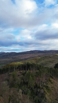 Aerial View of Balmaha Valley Glasgow Landscape over Mountains of UK During Sunset Time. The village is a popular tourist destination for picnickers and day trippers from Glasgow Scotland, UK