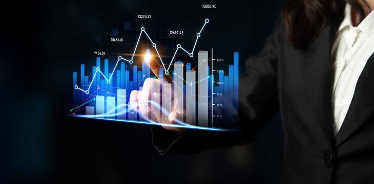 A business professional analyzes data trends using a digital graph, showcasing modern analytics and visualization in a financial environment for effective decision-making. Scalp