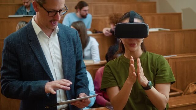 Professor guiding Korean female student using VR headset as she interacts with virtual touchscreen in air during university class with digital tablet.