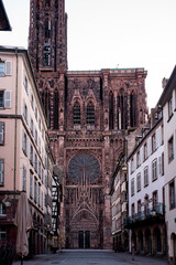 Fototapeta premium Towering Spire Rising Above Narrow Street Dramatic View