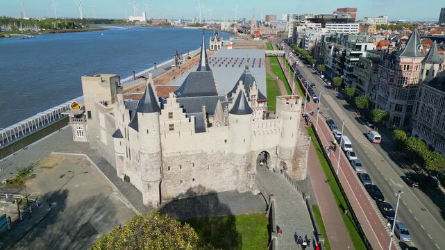 Aerial drone shot of Het Steen, a medieval fortress in the old city center of Antwerp, Belgium. View of the castle located on the banks of the Scheldt river.