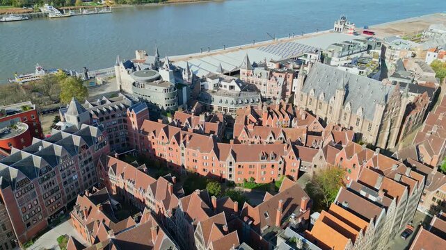 Aerial drone shot of the Grote Markt square in Antwerp, Belgium. Featuring the Renaissance Town Hall (Stadhuis), the Brabo Fountain statue, and historic guild houses.