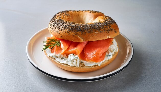 bagel with cream cheese and salmon on white plate