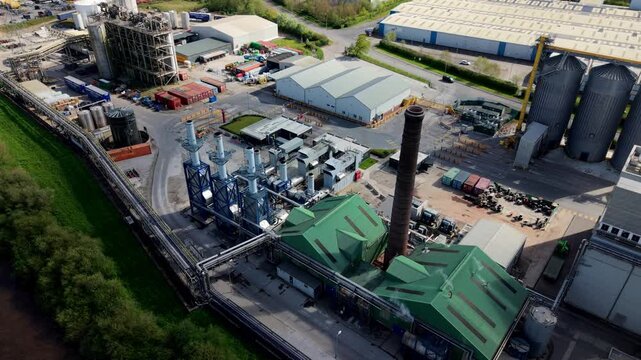 Aerial view of Sedamyl Industrial Factory with its green roofs, tall chimney, and industrial infrastructure in Selby, England, United Kingdom.