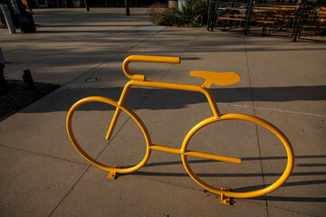 Obraz premium Looking down on a yellow bicycle rack in the shape of a ten speed bike in a shopping area
