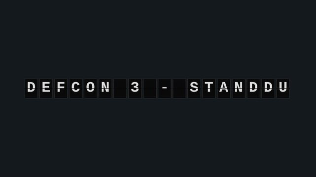 Mechanical splitflap solari board rapidly cycling letters to display a DEFCON 3 military threat alert