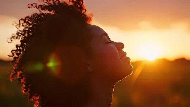 Serene Woman Embracing Golden Sunset Outdoors.