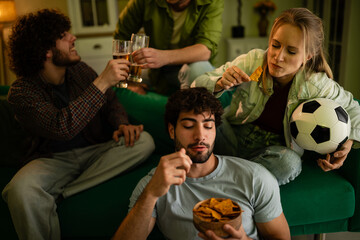 Friends watching soccer game on tv at home © Zoran Jesic