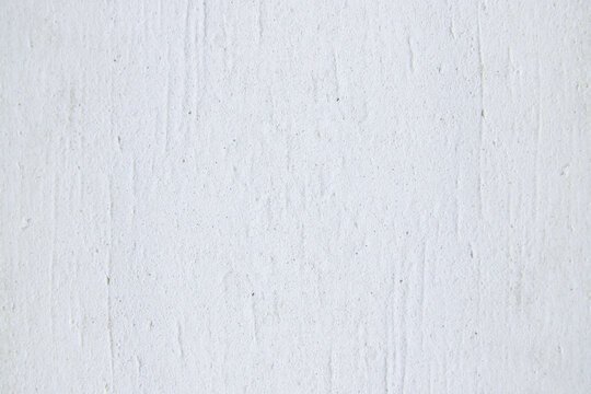 Close-up of unfinished plaster coating on wall prepared for renovation. Represents construction work, surface treatment, and interior restoration.