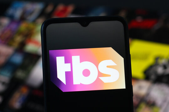 In this photo illustration, the TBS logo is seen displayed on a smartphone screen.