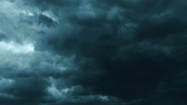 Low Angle Shot of Dark Storm Clouds Moving Fast Towards Camera. Dramatic cinematic footage of heavy dark storm clouds rolling low across the sky