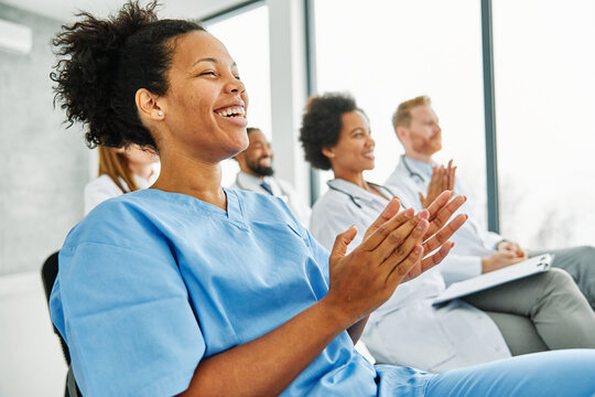 Portrait of a young doctors and nurses in audiance during a seminar in a board room or during an educational class at convention center