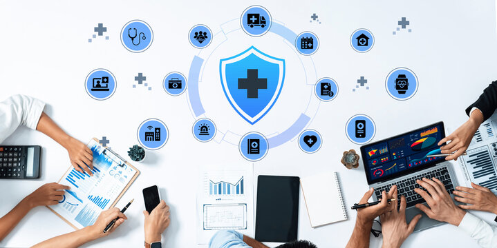 A modern office setup showcases teamwork in health management, featuring laptops, charts, and digital tools for effective data analysis and communication. Ledger