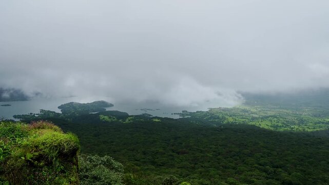 A timelapse showing monsoon clouds moving toward the plateau over a large lake and foresst, followed by a loss of visibility during the rainy season.