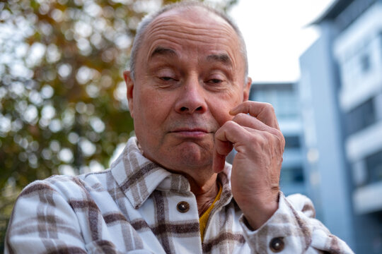 senior man skeptical face reveals suspicion, with expression, Emotional portrait doubtful look older man stands out, spontaneous reaction, genuine facial expression
