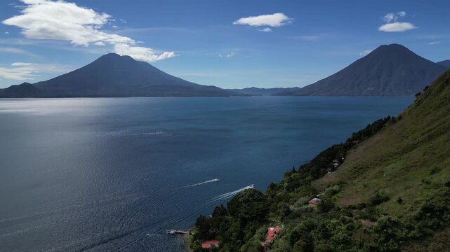 lake atitlan aerial drone footage (scenic volcanic lake with mountains background volcano volcanoes) santa cruz la laguna famous tourism destination latin america
