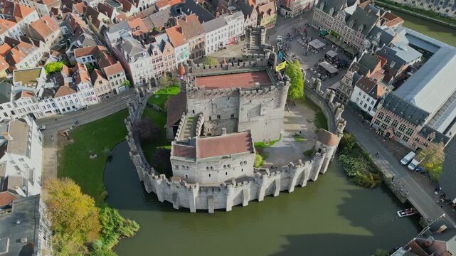 Aerial drone shot of the 10th-century Gravensteen Castle (Castle of the Counts) in Ghent, Belgium. Iconic medieval fortress with its moat and towers in the historic city center.