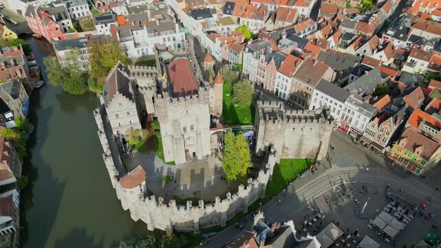 Aerial drone shot of the 10th-century Gravensteen Castle (Castle of the Counts) in Ghent, Belgium. Iconic medieval fortress with its moat and towers in the historic city center.