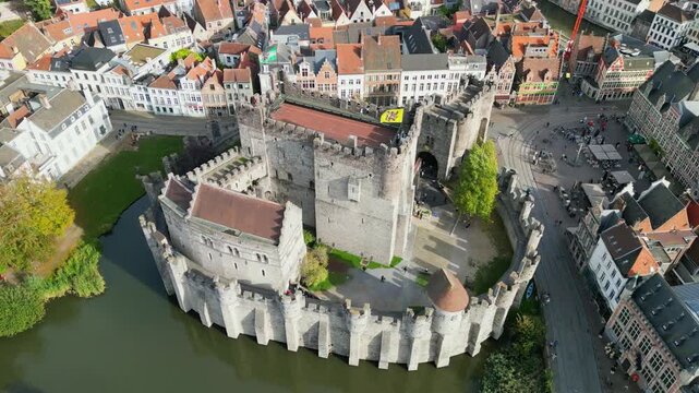 Aerial drone shot of the 10th-century Gravensteen Castle (Castle of the Counts) in Ghent, Belgium. Iconic medieval fortress with its moat and towers in the historic city center.