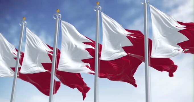 Bahrain national flags waving on a clear day. Seamless 3d render animation. Slow motion loop. Selective focus
