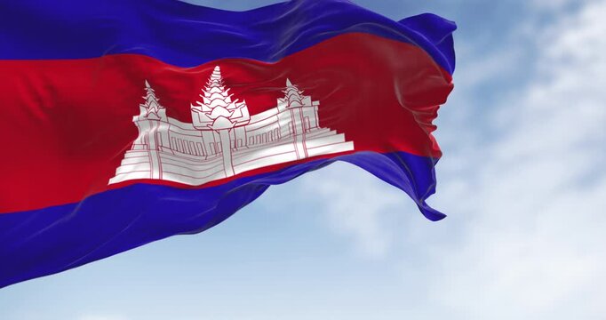 Cambodia national flag waving. Three bands, blue, double red, blue, with Angkor Wat in white centered on the red. Seamless 3d render animation. Slow motion loop. Selective focus