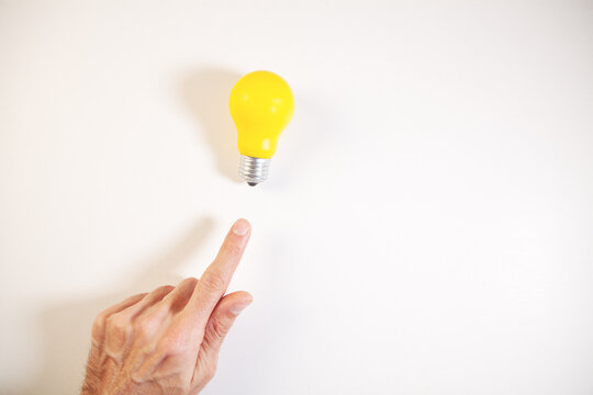 hand holding light bulb .