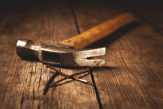 hammer and nails on a wood background