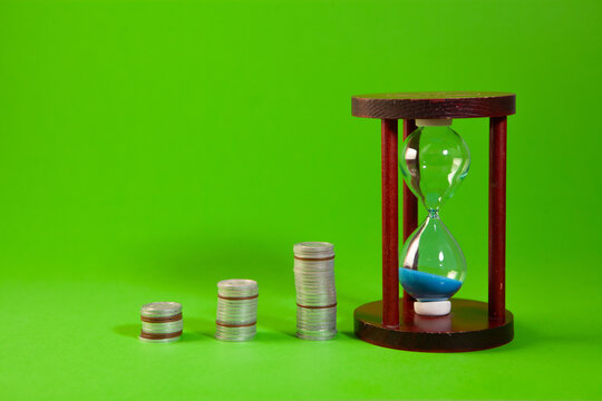 money in glass jar on a green background
