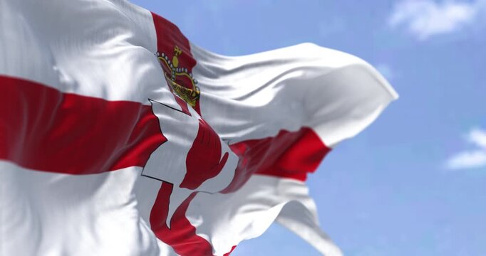 Close-up of Northern Ireland flag waving in the wind on a clear day. Part of the United Kingdom. Seamless 3d render animation. Slow motion loop. Selective focus