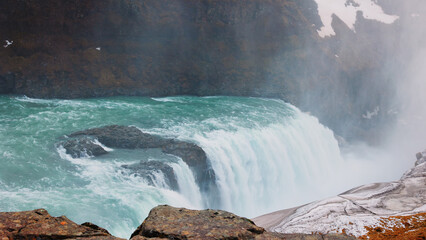 Gullfoss waterfall in nordic wilderness, spectacular icelandic landscape with snowy fields and freezing water falling off cliff. Arctic scenery on top of the hill, cascade in iceland. Handheld shot. © DC Studio
