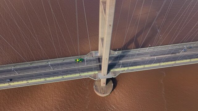 Aerial view of the Humber Bridge showing the pylon and suspension cables with traffic moving over the River Humber in Hessle, East Riding of Yorkshire, United Kingdom.