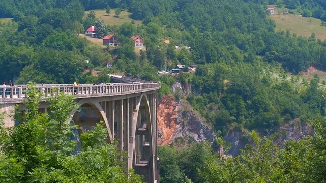 Durdevica tara bridge spanning the deep canyon. Historic durdevica tara bridge, a concrete arch structure spanning the deep tara river canyon, is a famous landmark and popular tourist destination