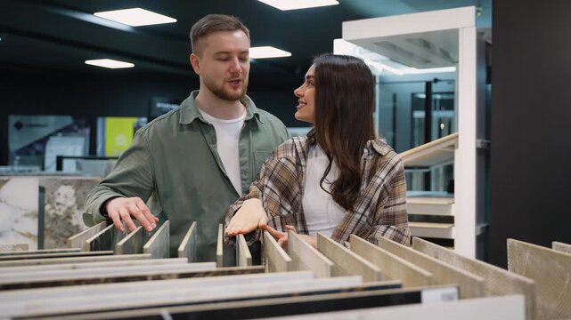 Young couple choosing ceramic tiles for home renovation