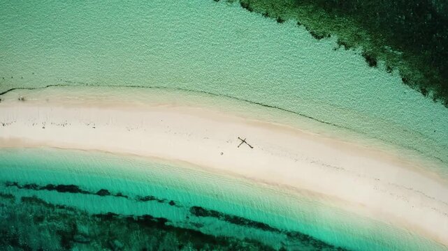 Aerial view of the pristine white sandbar of Dodola Island with crystal clear turquoise water and coral reefs Maluku, Indonesia.