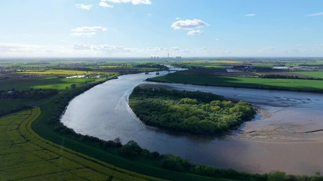 Aerial view of Howden Dyke Island on the River Ouse with industrial cooling towers in the distance Goole, England, United Kingdom.