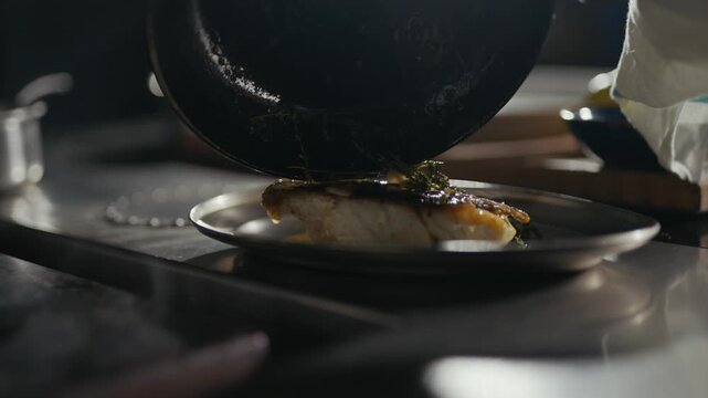 Chef pours golden sauce over seared fish. Plate gleams under warm kitchen lights. Focus remains on the dish, untouched by distractions. Gourmet food scene captures culinary artistry