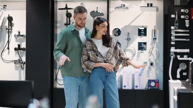 Young couple choosing bathroom shower fixtures