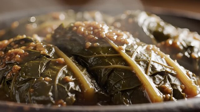 Closeup of steaming stuffed collard greens with a savory filling.