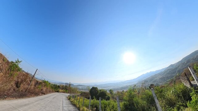 Camera Pan of Winding Mountain Highway from Right to Back Side with Motorcycle Engine Sound and Scenic View