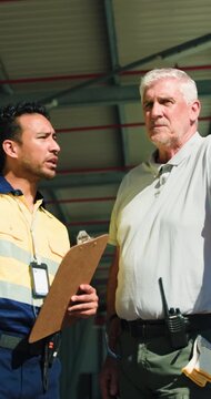 Clipboard, logistics and management with men outdoor together for delivery or shipping agenda. Collaboration, paperwork and update with happy supply chain team at distribution plant for planning