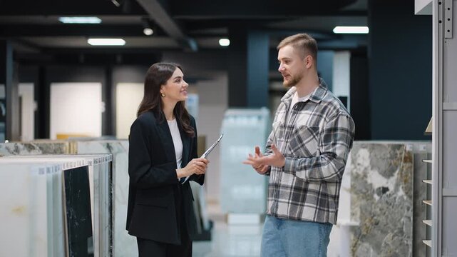 Saleswoman shaking hands with a customer in a tile showroom