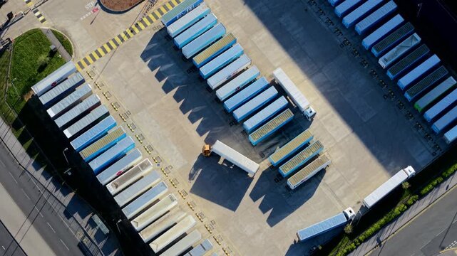 Aerial view of iPort Rail Limited logistics hub with rows of shipping containers and parked trailers in New Rossington, England, United Kingdom.
