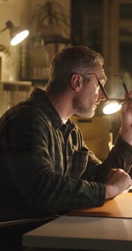 Creative, thinking and businessman with computer in office, night or editing article for publication. Serious, magazine editor and mature person with tech, glasses and working late for story deadline