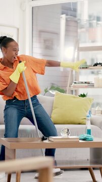 Happy, black woman and dancing with broom in home for fun cleaning, vibe or positive energy. Female person, housekeeping and cleaner singing with disinfection for hygiene, bacteria or dirt removal